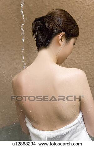Woman standing under the hot tap, hot water dropping, rear view, Japan View Large Photo Image Picture - Woman standing under the hot tap, hot water dropping, rear view, Japan. Fotosearch