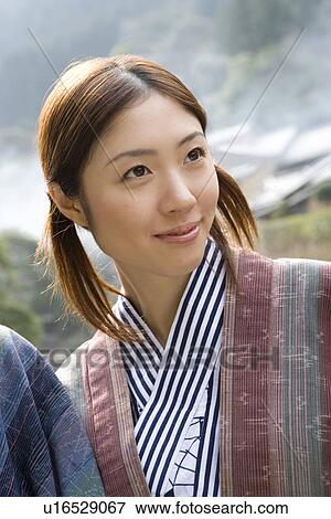 Stock Photo - Young Adult Woman Wearing Yukata, Front View, Head and Shoulder. Fotosearch