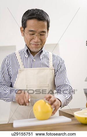 A Mature Adult Man Cutting a Grapefruit, Front View, Differential Focus View Large Photo Image Stock Image - A Mature Adult Man Cutting a Grapefruit, Front View, Differential Focus. Fotosearch