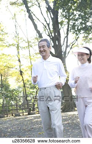 Stock Photo - A Senior Adult Couple Jogging Together, Side View, Front View. Fotosearch