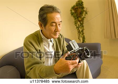 A Senior Adult Man Caring His Camera, Side View, High Angle View View Large Photo Image Stock Photography - A Senior Adult Man Caring His Camera, Side View, High Angle View. Fotosearch