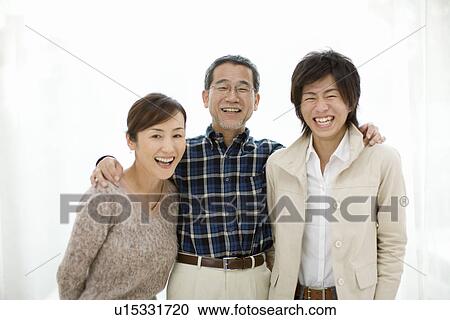 Stock Image - A Family Smiling at Camera, Front View, Portrait. Fotosearch