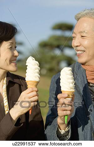 A Mature Couple Having Ice Cream, Waist Up, Front View, Side View, Differential Focus View Large Photo Image Stock Photo - A Mature Couple Having Ice Cream, Waist Up, Front View, Side View, Differential Focus. Fotosearch