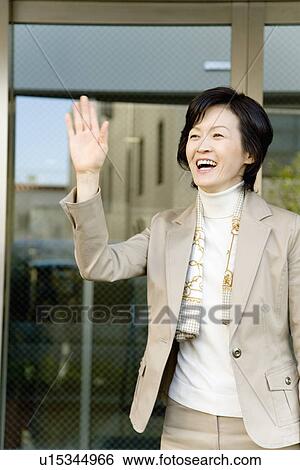 A Mature Woman Greeting with a Raised Hand, Front View, Waist Up View Large Photo Image Stock Photograph - A Mature Woman Greeting with a Raised Hand, Front View, Waist Up. Fotosearch