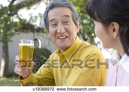 A Senior Adult Couple Drinking Beer in a Garden, Side View, Differential Focus View Large Photo Image Stock Image - A Senior Adult Couple Drinking Beer in a Garden, Side View, Differential Focus. Fotosearch