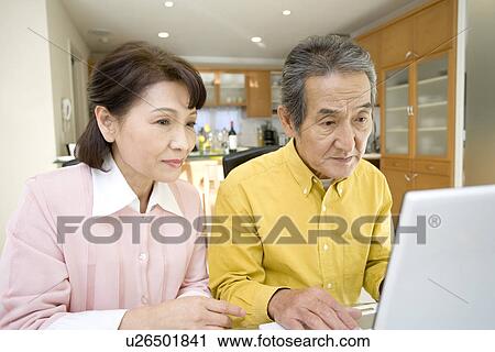 A Senior Adult Couple Using a Laptop Computer Together, Front View, Side View View Large Photo Image Stock Image - A Senior Adult Couple Using a Laptop Computer Together, Front View, Side View. Fotosearch