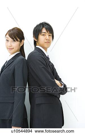 Picture - Businessman And Businesswoman Standing Back To Back, Side View, Waist Up,. Fotosearch
