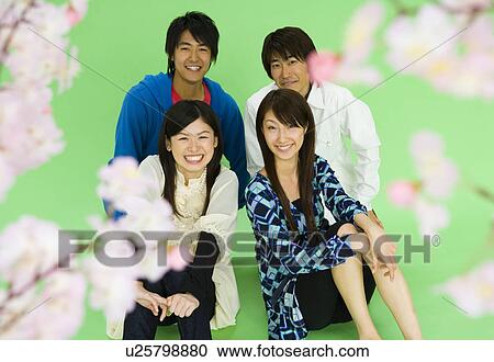 Portrait of four young people with cherry flowers, smiling and looking at camera, front view, green background View Large Photo Image Stock Image - Portrait of four young people with cherry flowers, smiling and looking at camera, front view, green background. Fotosearch
