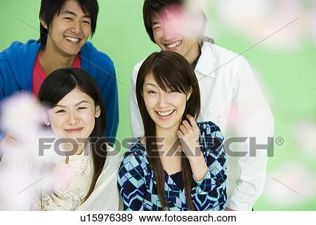 Portrait of four young people with cherry flowers, smiling and looking at camera, front view, green background View Large Photo Image Stock Photo - Portrait of four young people with cherry flowers, smiling and looking at camera, front view, green background. Fotosearch