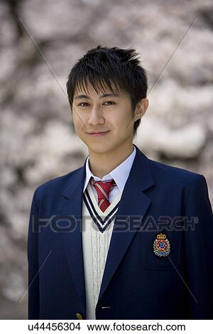 Picture - Portrait of High School Boy with Cherry Blossoms in the Background. Fotosearch