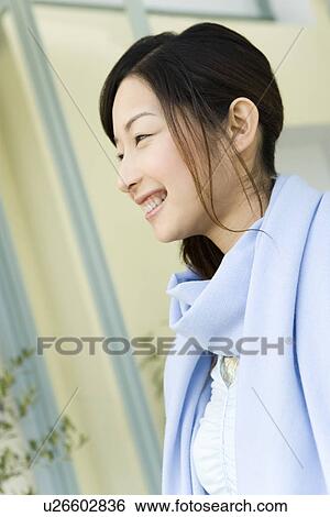 Stock Photograph - Profile of a smiling a woman, side view, differential focus. Fotosearch