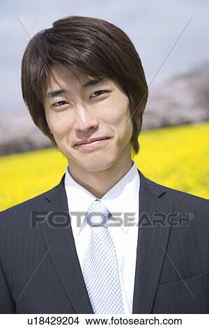 Smiling Businessman In Rape Blossoms, Portrait, Front View, Differential Focus View Large Photo Image Picture - Smiling Businessman In Rape Blossoms, Portrait, Front View, Differential Focus. Fotosearch