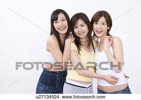 Picture - Three young women, smiling, front view. Fotosearch