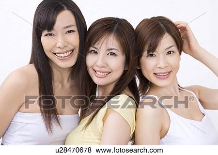 Stock Photo - Three young women, smiling, front view. Fotosearch