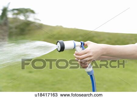 Close up of a human hand, using a hosepipe View Large Photo Image Stock Image - Close up of a human hand, using a hosepipe. Fotosearch