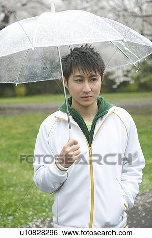 Portrait of a man holding an umbrella, front view, Japan View Large Photo Image Stock Photograph - Portrait of a man holding an umbrella, front view, Japan. Fotosearch