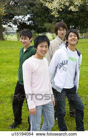 Portrait of four young men on lawn, smiling and looking at camera, front view, side view, Japan View Large Photo Image Picture - Portrait of four young men on lawn, smiling and looking at camera, front view, side view, Japan. Fotosearch
