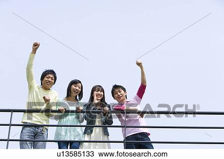 Portrait of four young people, men punching air, low angle view, blue background, copy space, Japan View Large Photo Image Stock Image - Portrait of four young people, men punching air, low angle view, blue background, copy space, Japan. Fotosearch