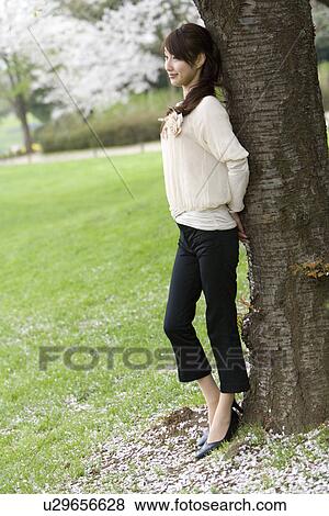 Young Woman Leaning on Wood, Side View View Large Photo Image Stock Photo - Young Woman Leaning on Wood, Side View . Fotosearch