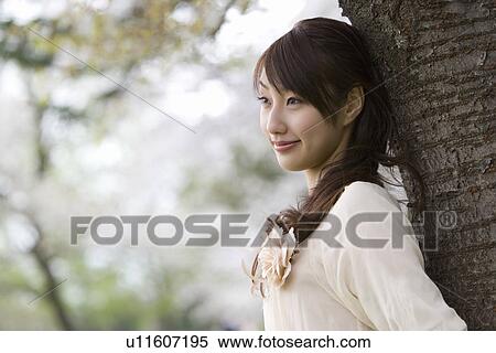 Young Woman Leaning on Wood, Differential Focus, Side View View Large Photo Image Stock Photography - Young Woman Leaning on Wood, Differential Focus, Side View. Fotosearch