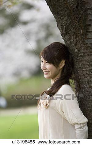 Young Woman Leaning on Wood, Differential Focus, View Large Photo Image Stock Photography - Young Woman Leaning on Wood, Differential Focus, . Fotosearch