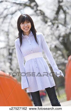 Young Woman Smiling, Differential Focus, Front View View Large Photo Image Stock Image - Young Woman Smiling, Differential Focus, Front View. Fotosearch