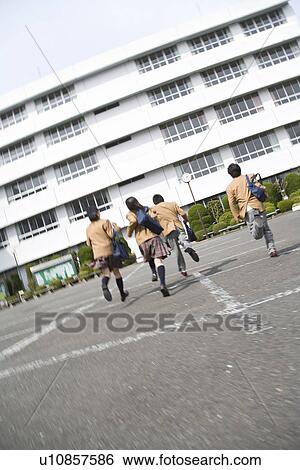 Four high school students running to school building, blurred motion View Large Photo Image Stock Photograph - Four high school students running to school building, blurred motion. Fotosearch
