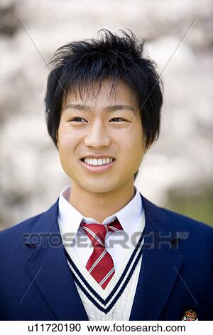 Stock Image - High School Boy Eating Hamburger. Fotosearch