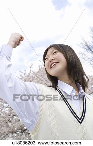 Stock Image - High School Girl Holding Fist Up in the Air. Fotosearch