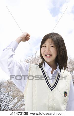 Stock Photography - High School Girl Holding Fist Up in the Air. Fotosearch