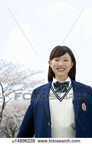High School Girl Spreading Arms, Cherry Blossoms in the Background View Large Photo Image Stock Photo - High School Girl Spreading Arms, Cherry Blossoms in the Background. Fotosearch