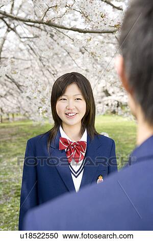 High School Student Girl Talking in Field with Cherry Blossom in the Background, Differential Focus View Large Photo Image Stock Image - High School Student Girl Talking in Field with Cherry Blossom in the Background, Differential Focus. Fotosearch