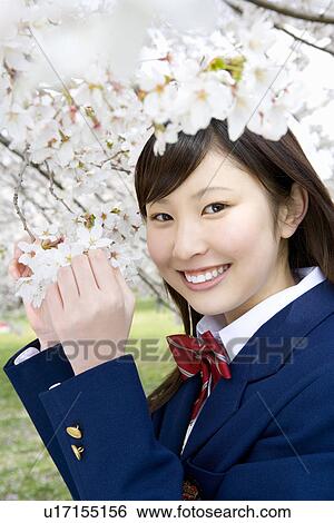 Stock Photograph - High School Student Girl with Cherry Flowers. Fotosearch