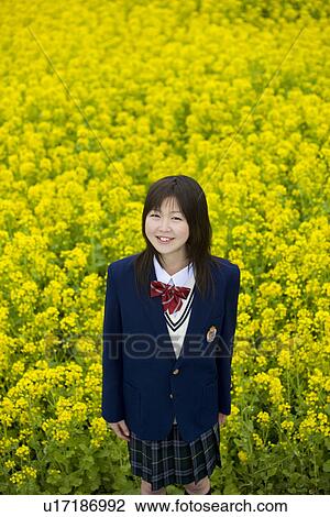 Stock Image - High School Student In Rape Seed Blossom Field. Fotosearch