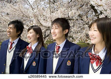 Stock Photography - High School Students in a Row in Front of Cherry Blossoms. Fotosearch