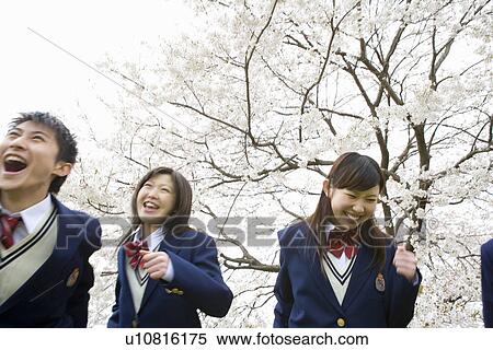 Stock Photography - High School Students Running Under The Cherry Blossoms. Fotosearch