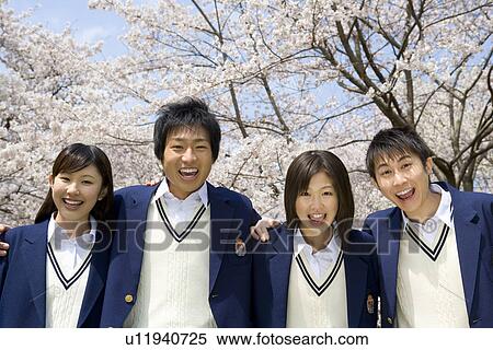 Stock Photography - High School Students Standing In a Row in School Yard with Fists Up. Fotosearch
