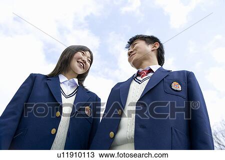 Stock Image - High School Students Standing Under the Blue Sky. Fotosearch