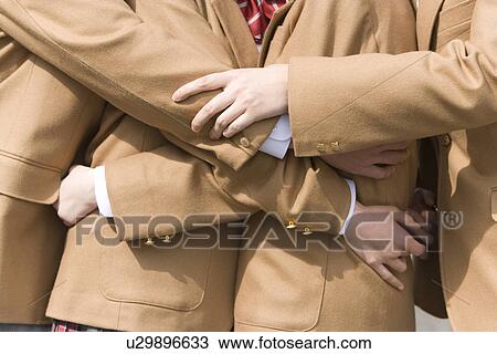 Stock Image - Mid Section of High School Students Hugging Each Other. Fotosearch