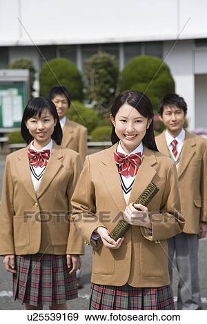 Portrait of four high school students smiling and looking at camera, a girl holding diploma View Large Photo Image Stock Photo - Portrait of four high school students smiling and looking at camera, a girl holding diploma. Fotosearch