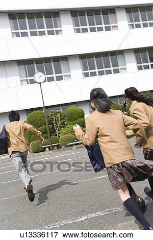 Three high school students running to school building View Large Photo Image Stock Photo - Three high school students running to school building. Fotosearch
