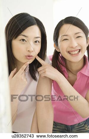 Portrait of Two Young Twin Sisters, Smiling, Front View View Large Photo Image Stock Image - Portrait of Two Young Twin Sisters, Smiling, Front View. Fotosearch