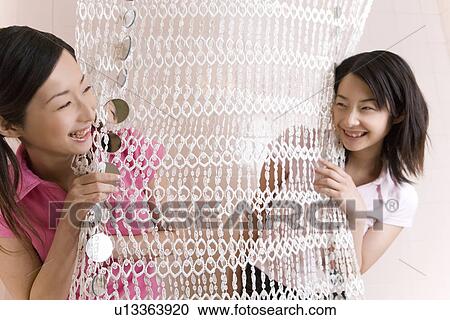 Two Young Twin Sisters Holding a Curtain, Smiling, Side View View Large Photo Image Stock Image - Two Young Twin Sisters Holding a Curtain, Smiling, Side View. Fotosearch