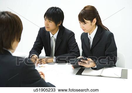 Stock Image - Businessman and Businesswoman In Meeting, Side View. Fotosearch