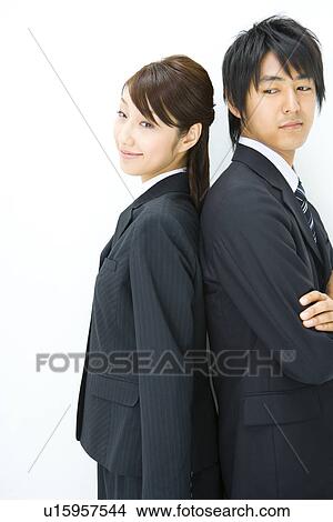 Picture - Businessman And Businesswoman Standing Back To Back, Side View, Waist Up,. Fotosearch