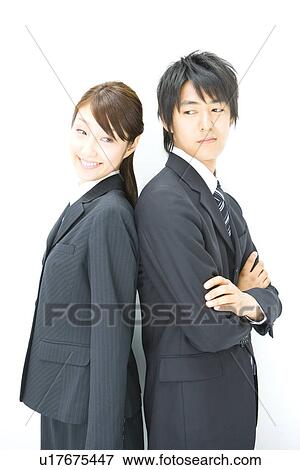 Stock Photo - Businessman And Businesswoman Standing Back To Back, Side View, Waist Up,. Fotosearch