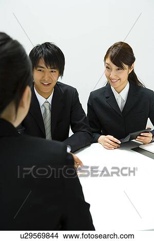 Businessman and Businesswomen In Meeting, Front View, Rear View View Large Photo Image Picture - Businessman and Businesswomen In Meeting, Front View, Rear View. Fotosearch