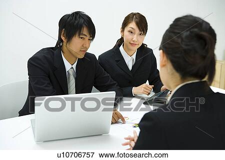 Stock Photo - Businessman and Businesswomen In Meeting, Rear View, Front View. Fotosearch