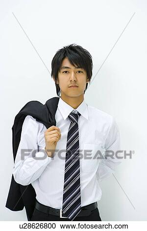 Stock Image - Businessman Shouldering Jacket, Front View, Waist Up, Portrait. Fotosearch