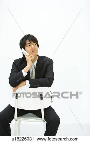 Stock Image - Businessman Using a Mobile Phone, Front View, Copy Space . Fotosearch
